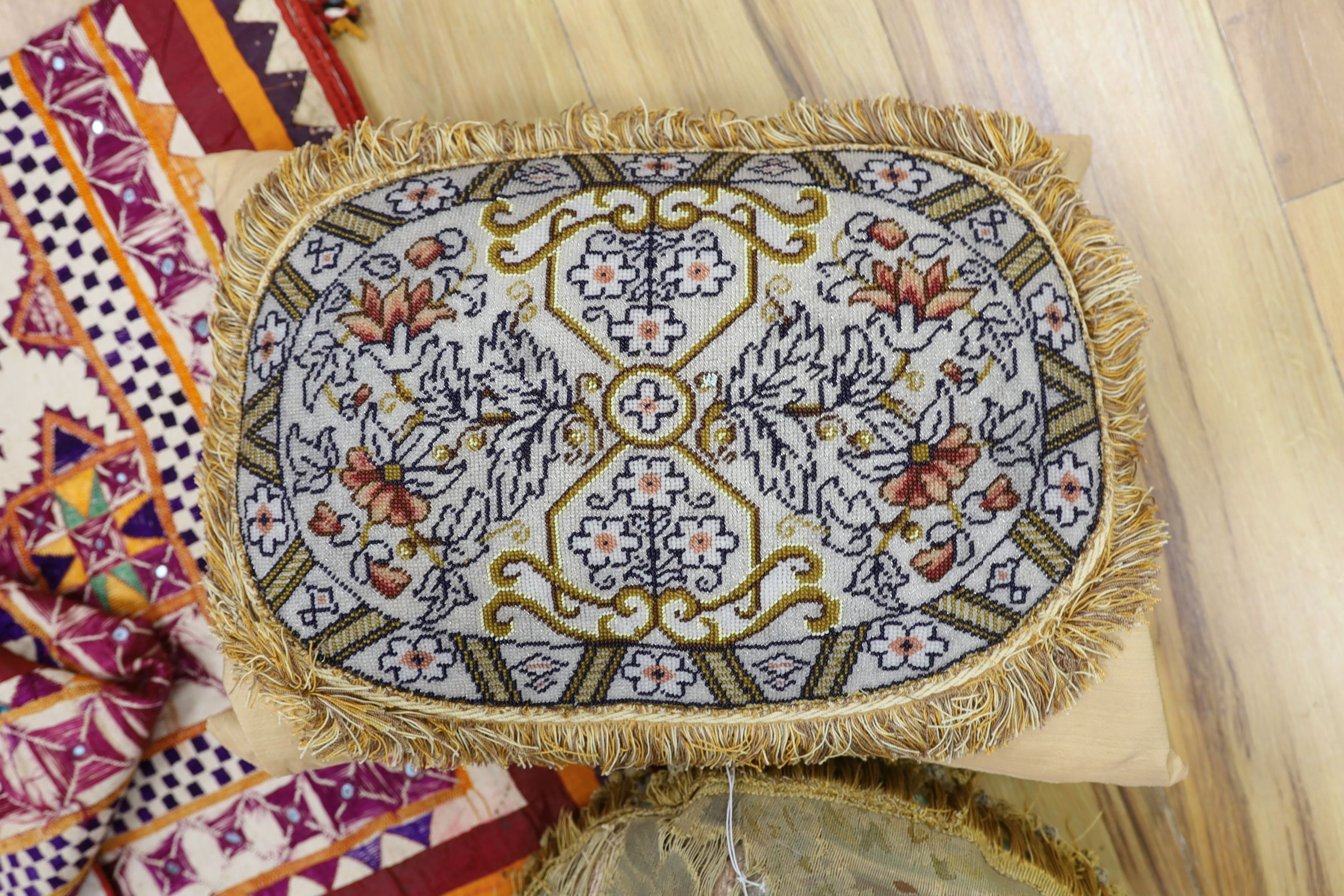 An Indian embroidered cover and cushions